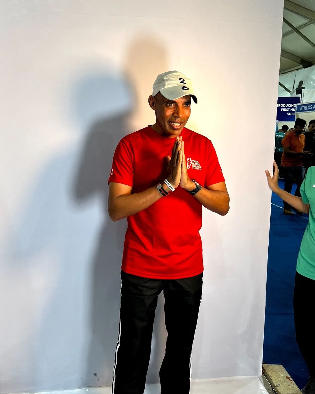 Meb Keflezighi at the Tata Mumbai Marathon expo, hands folded in namaste