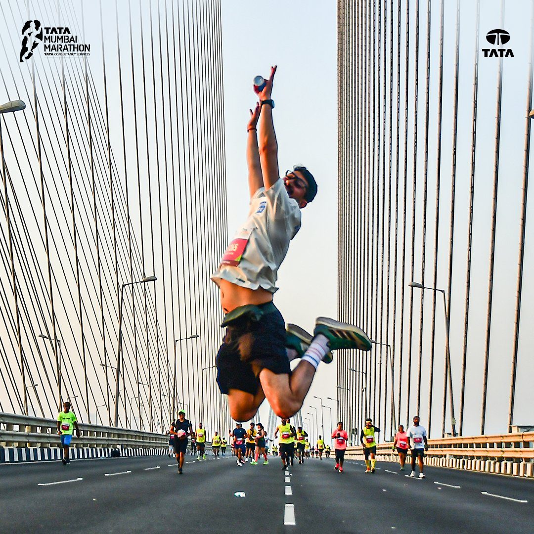 Runner mid-jump on the Bandra-Worli Sea Link during the Tata Mumbai Marathon